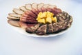 White dish with sliced Ã¢â¬â¹Ã¢â¬â¹meat products and cheese on a light background Royalty Free Stock Photo